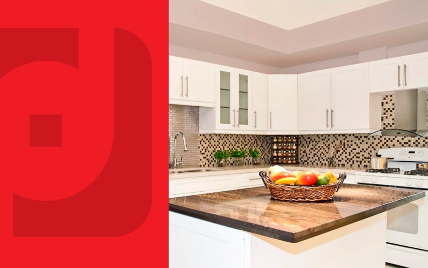 Kitchen with brown countertops, white shaker cabinets and a fruit basket