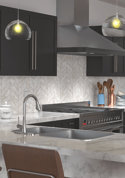 a kitchen with gray cabinets and a stainless steel refrigerator